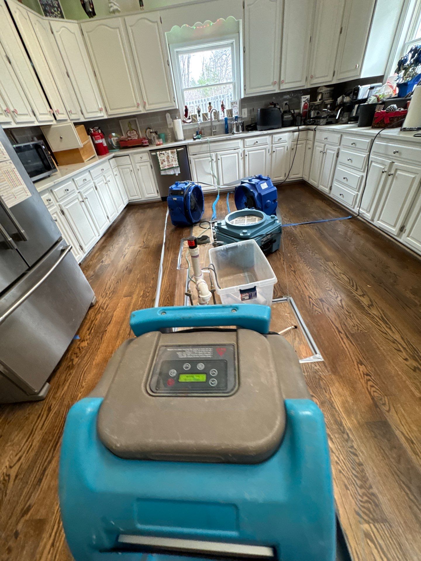 Dehumidification and air circulation during mid-stage water restoration process.
