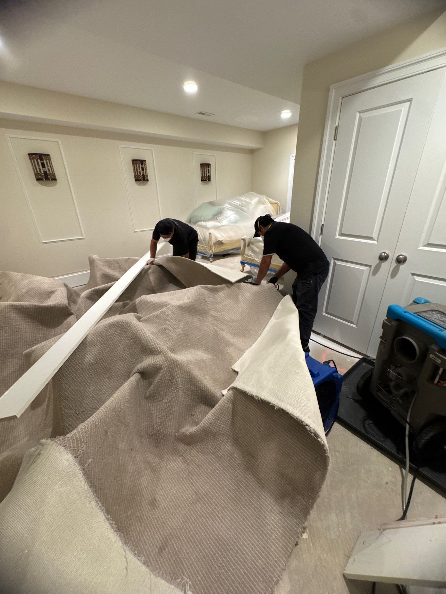 Dehumidifiers and air movers running to dry structural materials after water extraction.