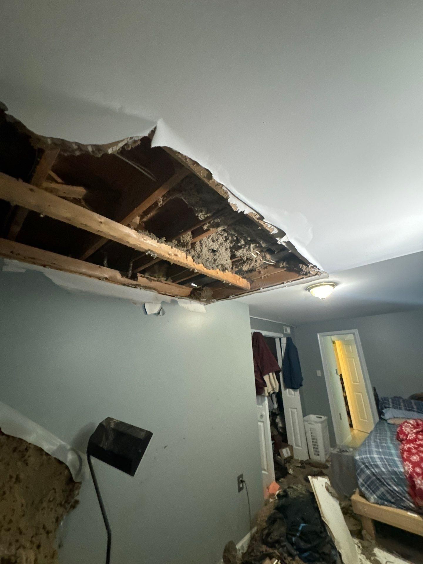 Protective sheeting and containment setup during water damage ceiling repair in Woodbridge.