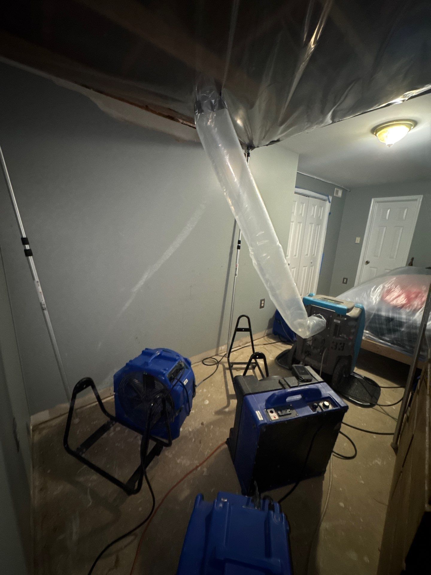 Removed ceiling materials and exposed framing during water restoration work in Woodbridge.
