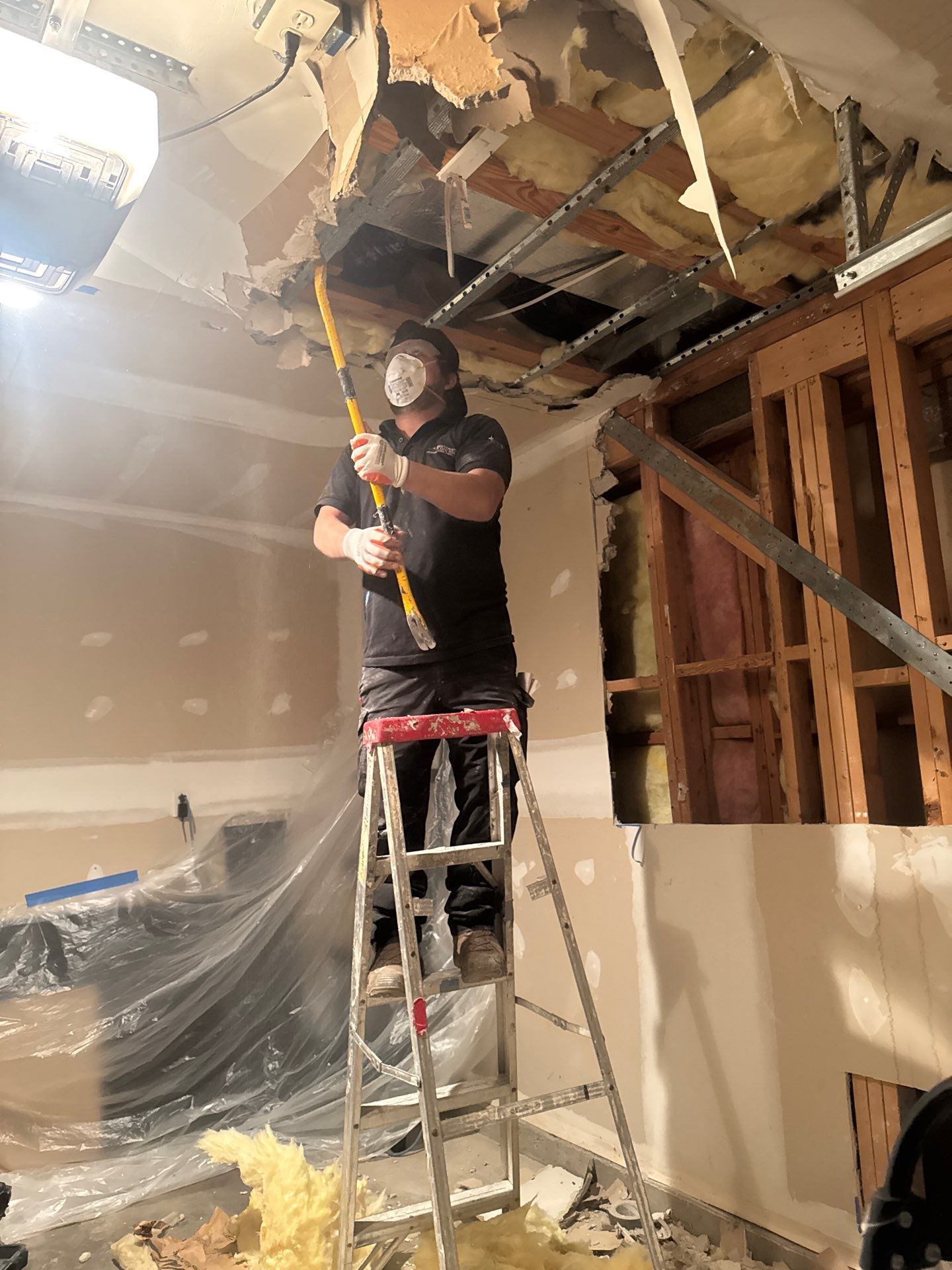 Structural drying setup with dehumidifiers and air movers positioned to manage moisture in damaged spaces.