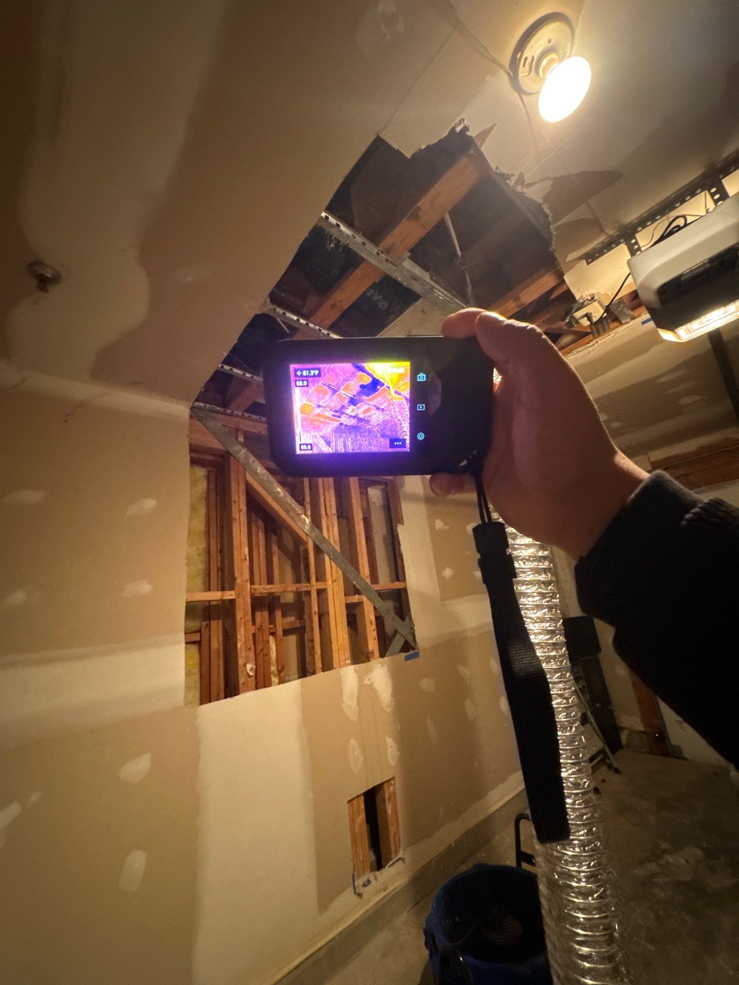 Containment and removal of water-damaged drywall sections prior to replacement installation.