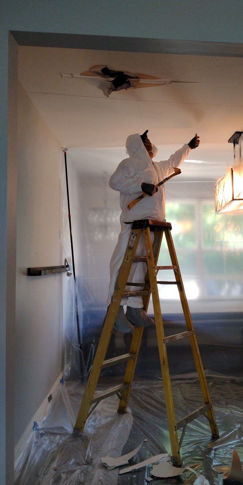 Mid-stage containment and drying setup for mold remediation, with ceiling repair preparation underway.
