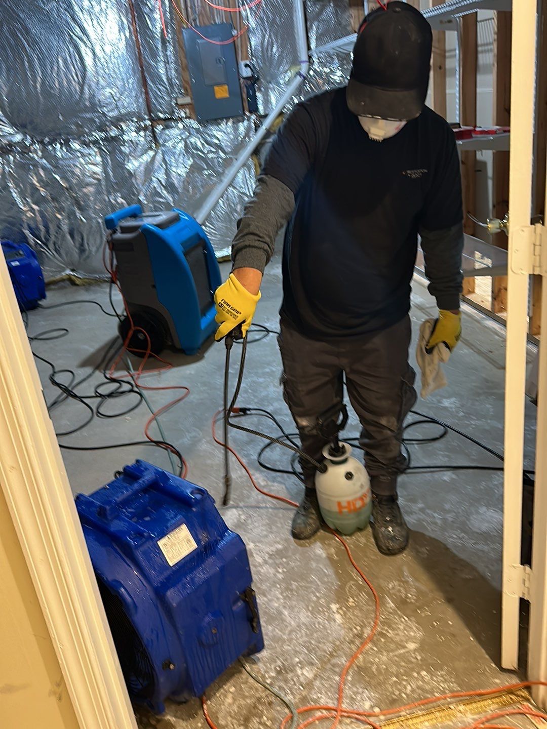 Dehumidification equipment positioned for structural drying phase of water restoration.