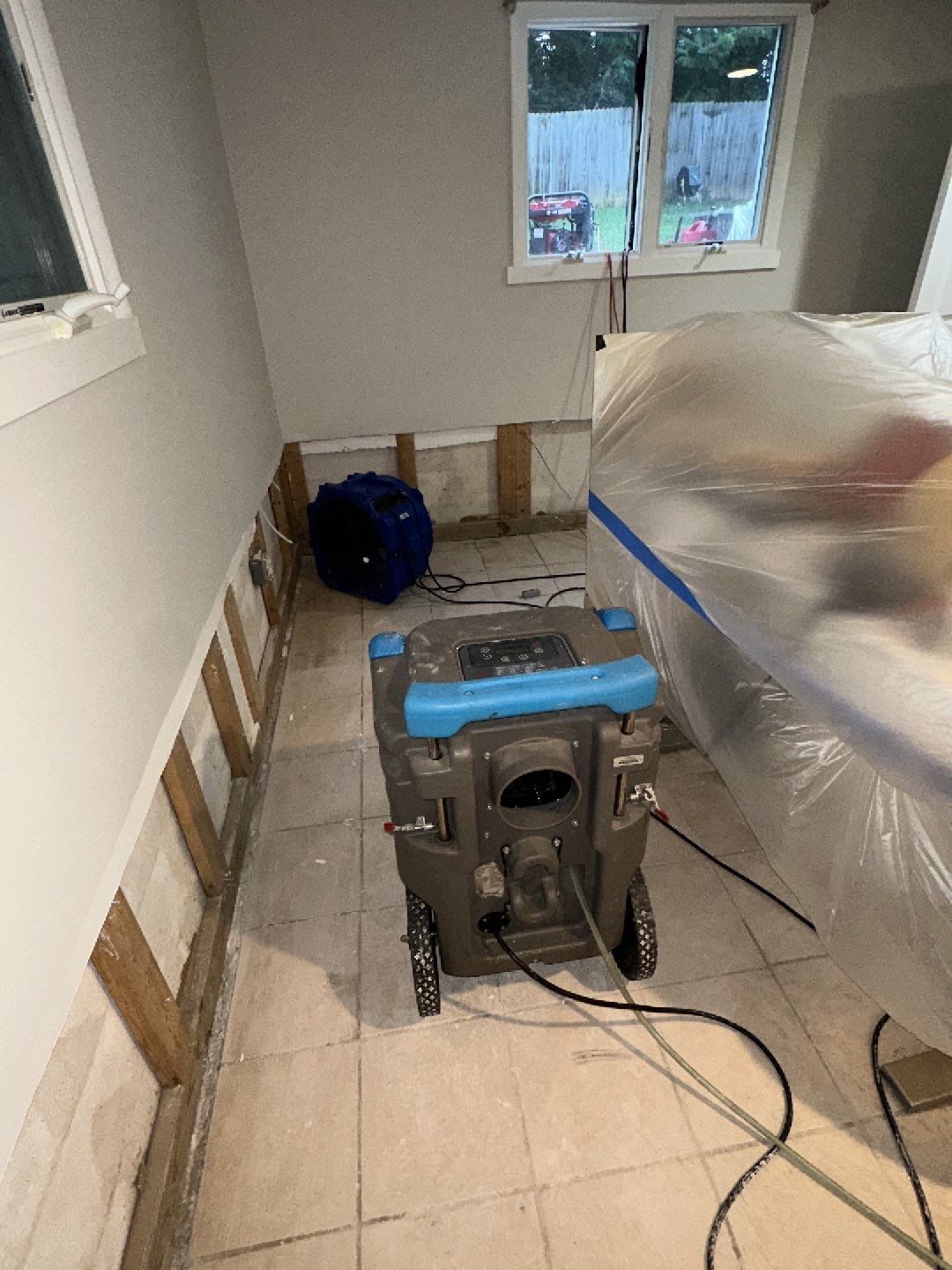 Water damage restoration in Oakton: dehumidification and drying equipment deployed in affected interior space.