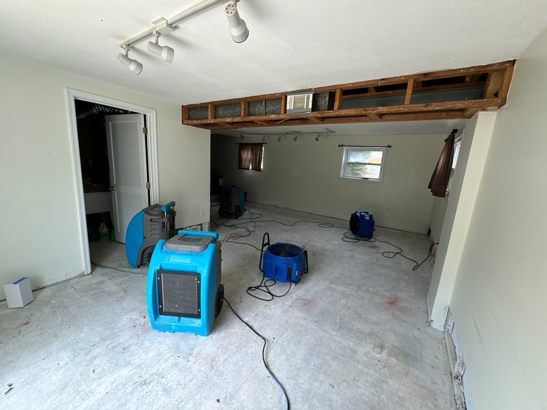 Dehumidification equipment positioned for structural drying in affected areas.