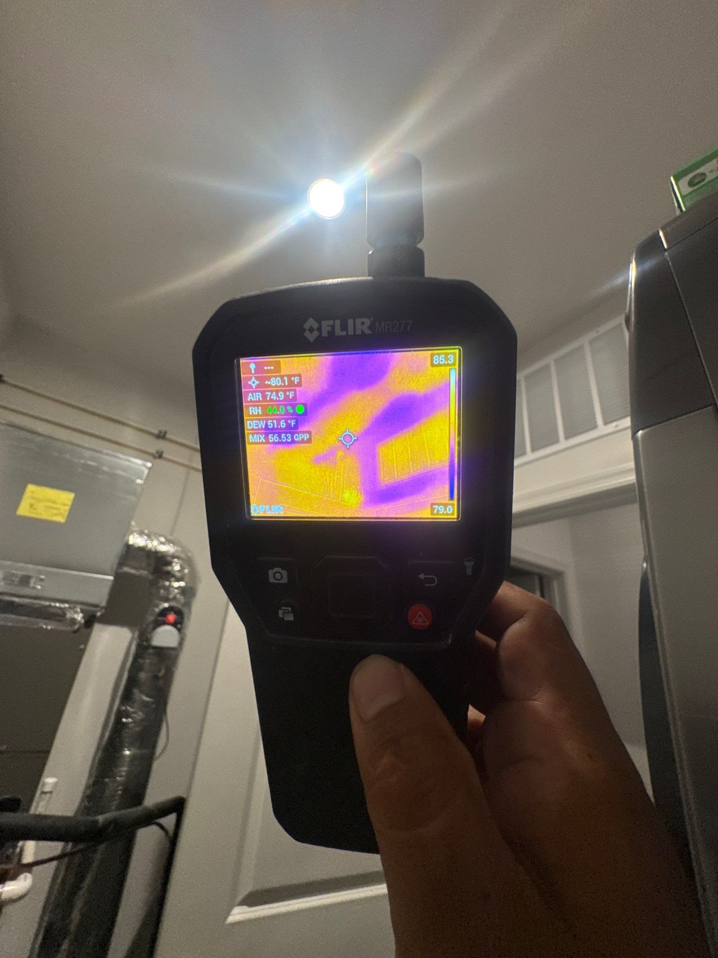 Thermal imaging reveals moisture distribution across ceiling framing during water damage assessment in Woodbridge.
