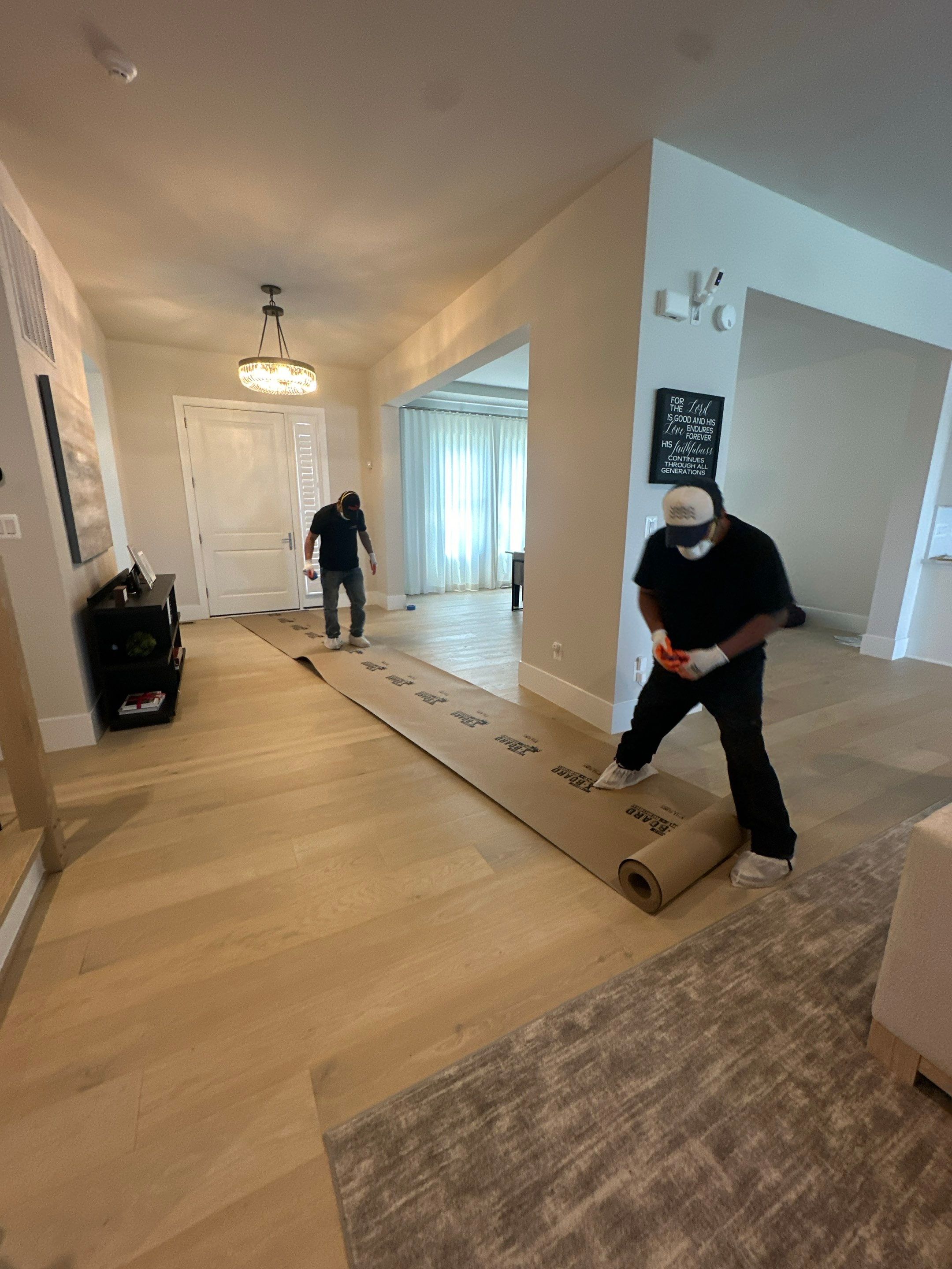 Flooring removal in progress, documenting moisture patterns beneath the surface layer.