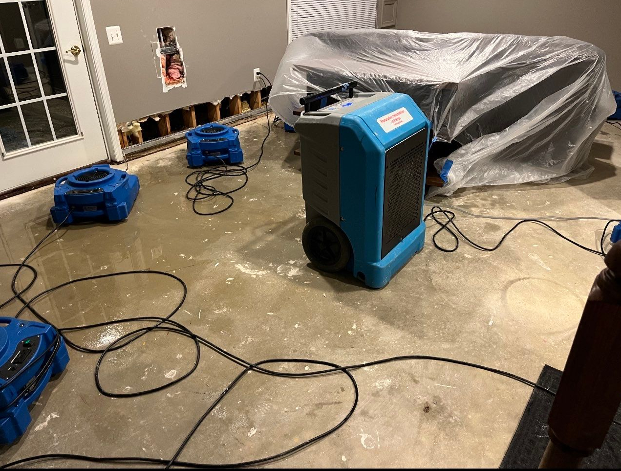 Dehumidification equipment positioned for structural drying during moisture remediation.
