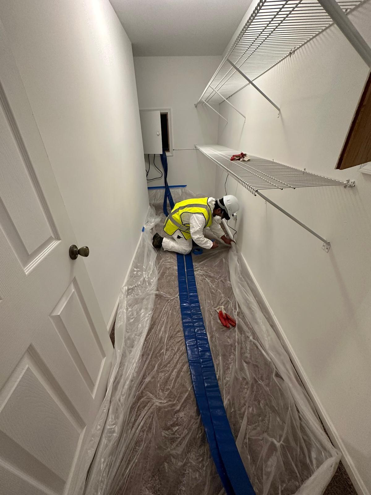 Industrial dehumidifiers positioned throughout affected room during drying phase.