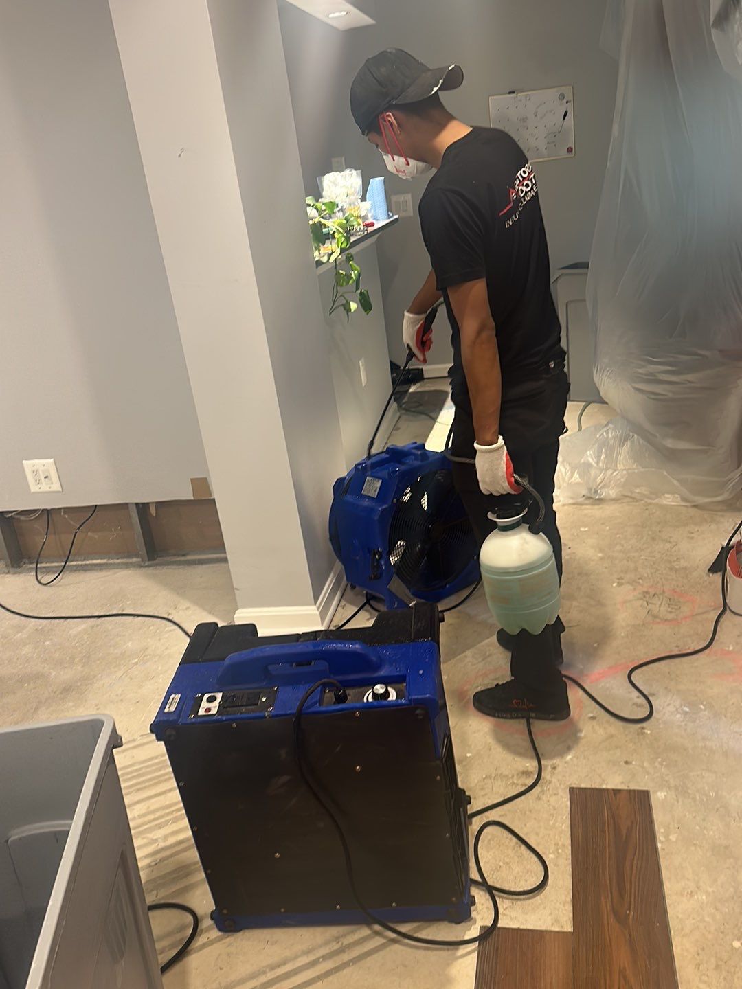 Mid-stage drying phase showing dehumidifiers and air movers working to remove residual moisture.