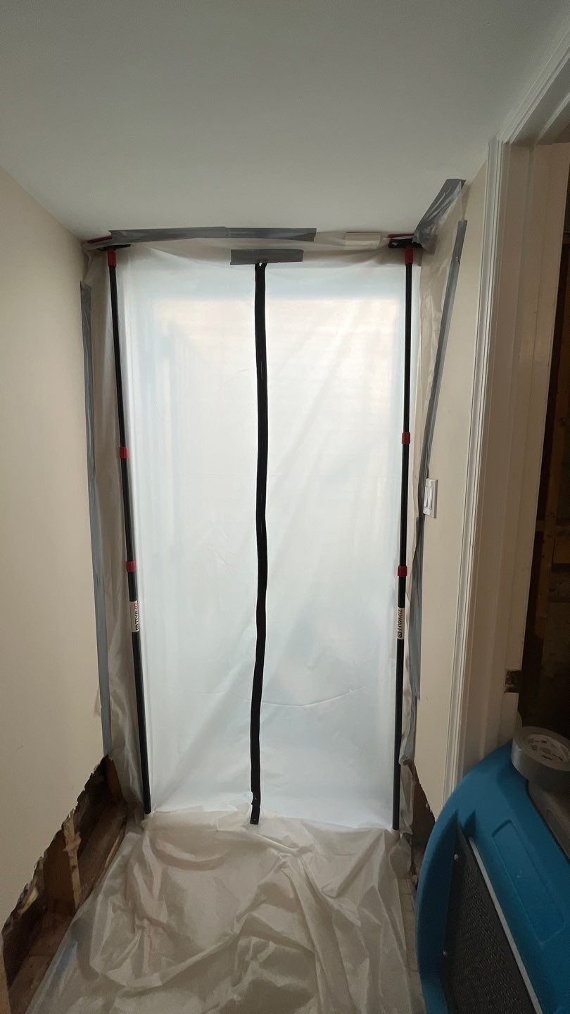 Dehumidifiers and air movers operating in water-damaged space during Washington restoration work.