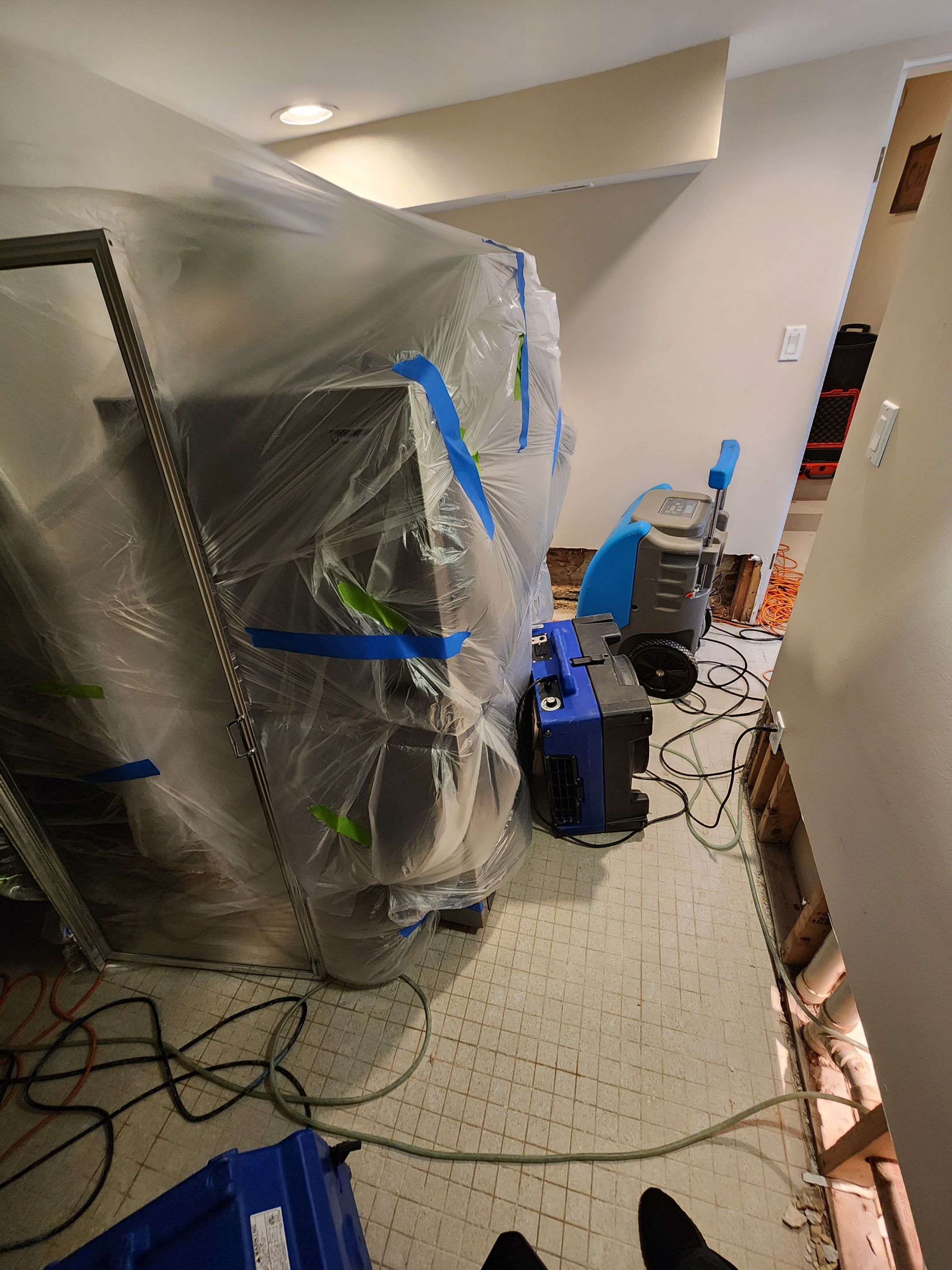 Structural drying equipment positioned during mid-stage water damage restoration in Washington.