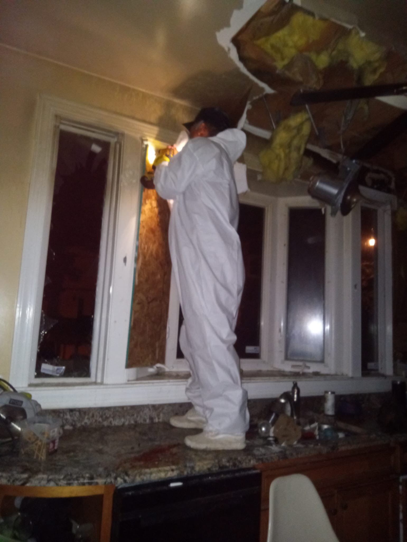 Structural drying in progress with dehumidifiers and air movers positioned throughout the space.