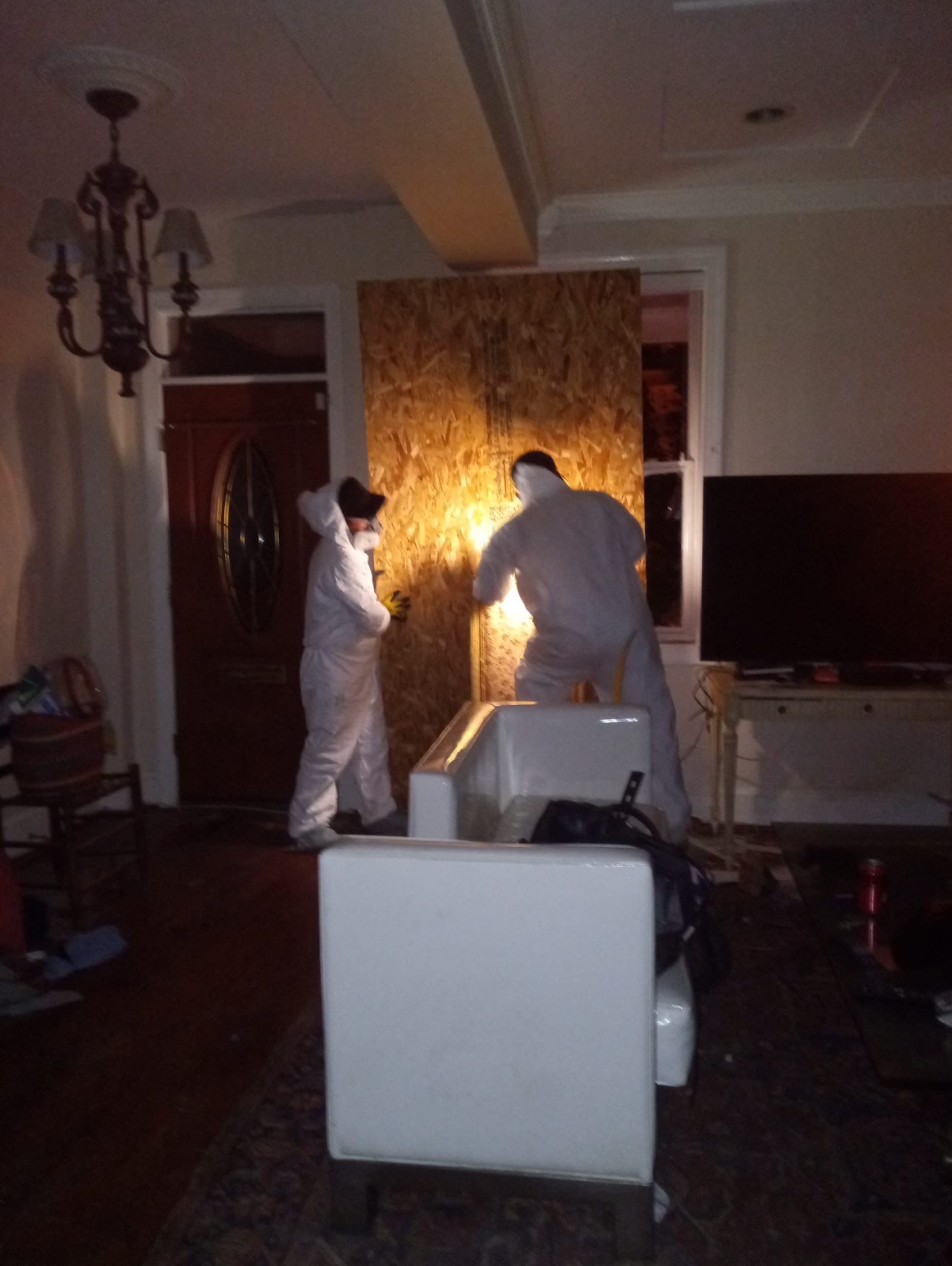 Standing water removal underway in Washington water damage restoration, extractors deployed across affected floor.