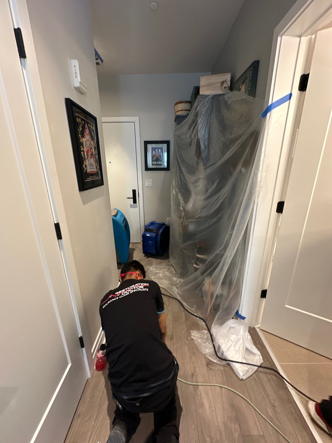 Water damage restoration in Washington: structural drying equipment positioned in affected room during initial assessment.