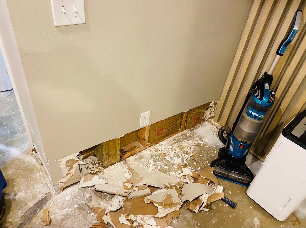 Final-stage water damage restoration showing cleared space and completed dehumidification setup.