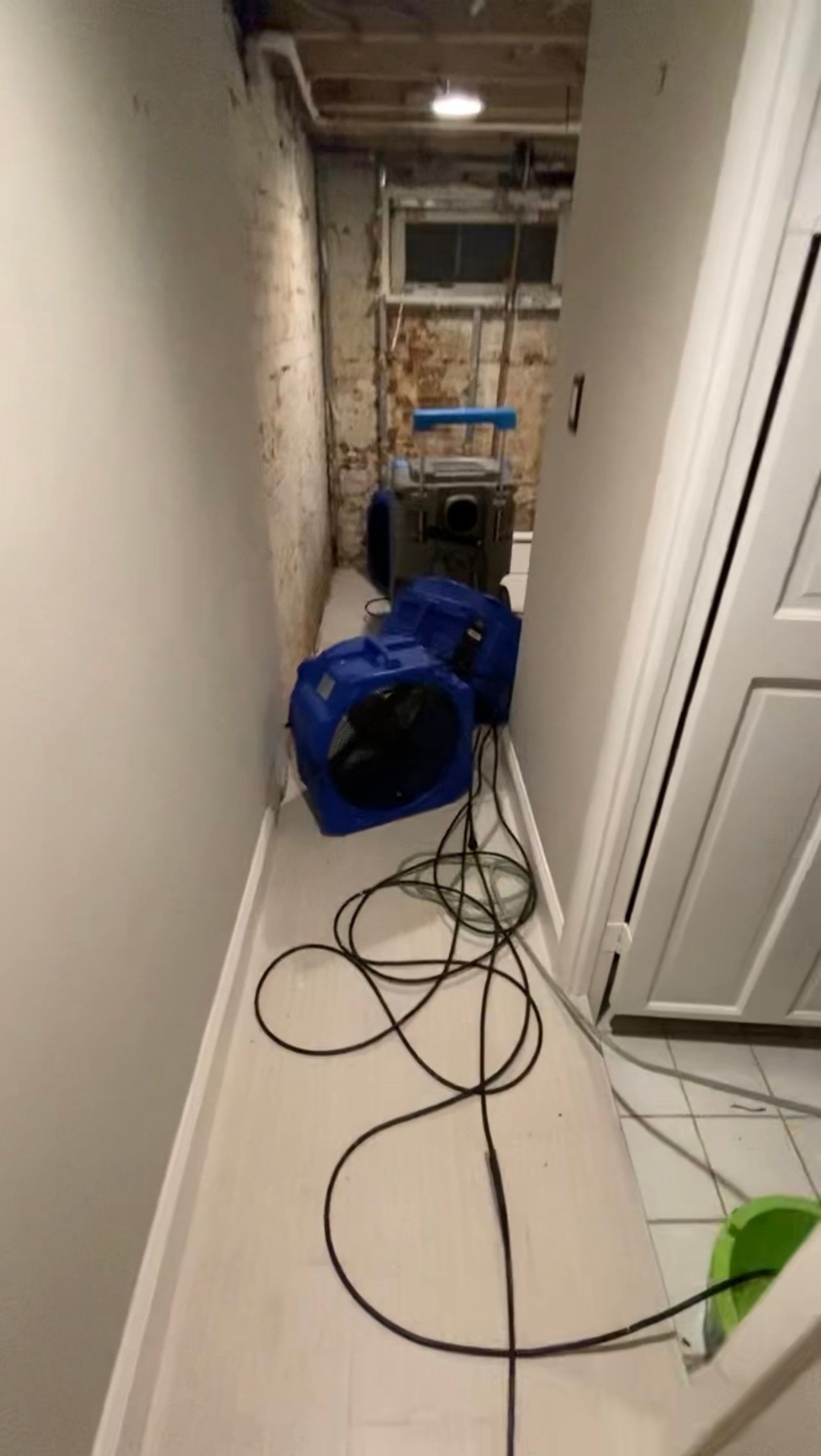 Standing water extraction underway during water damage restoration in Washington, using truck-mounted equipment.