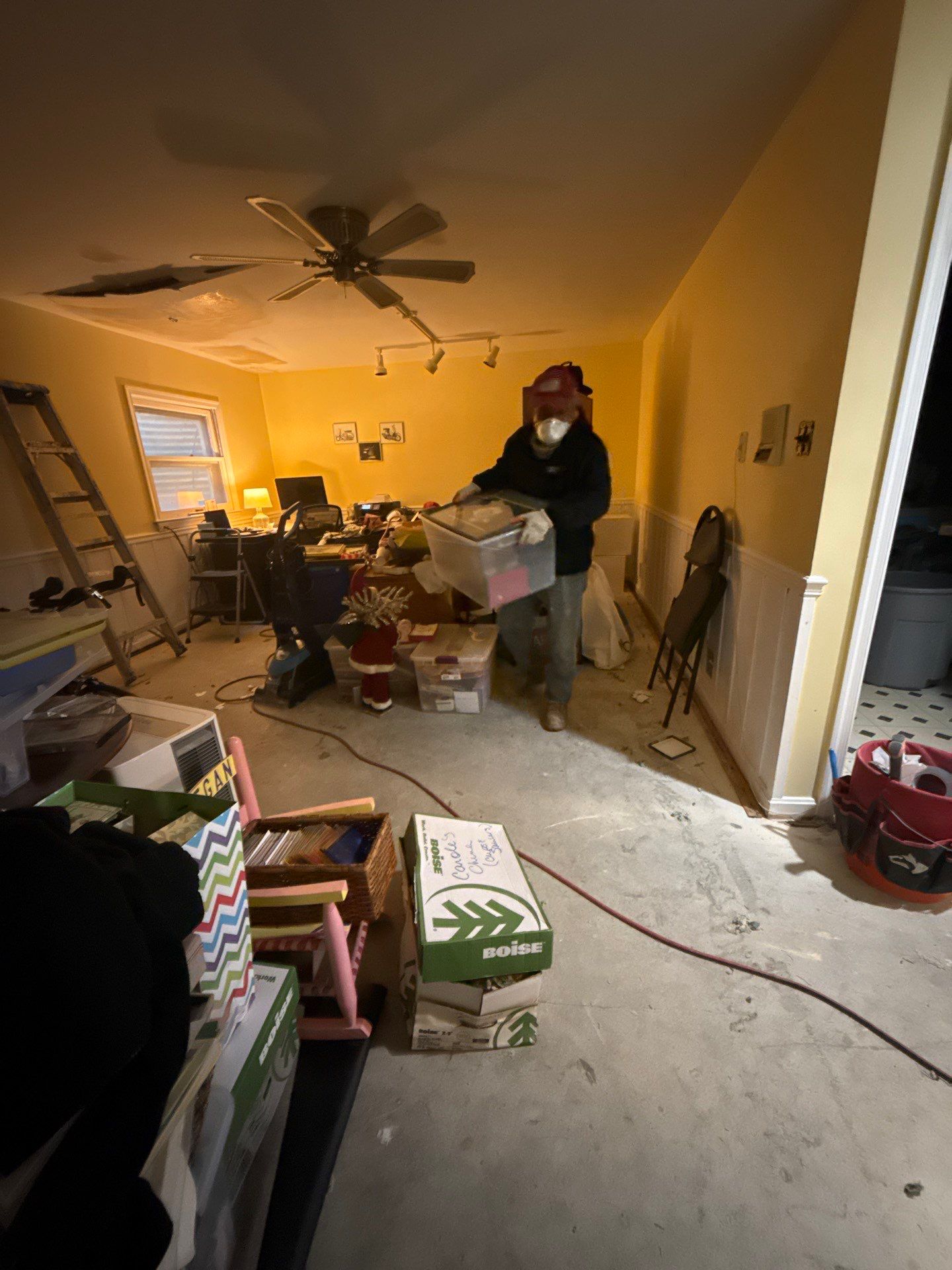 Baseboard and lower wall framing exposed during remediation to assess and dry moisture-damaged material.