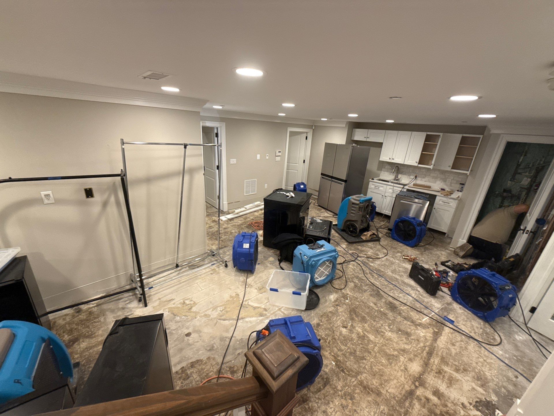 Structural drying in progress with dehumidification equipment positioned throughout containment zone.