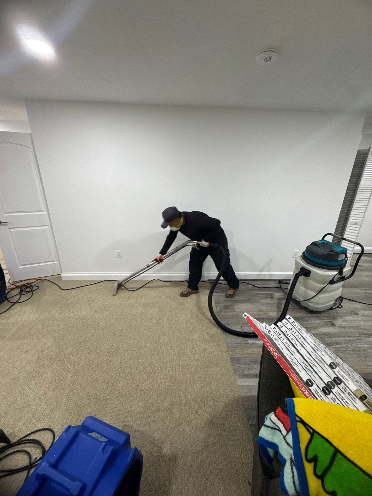 Water extraction equipment deployed across affected flooring during structural drying process.