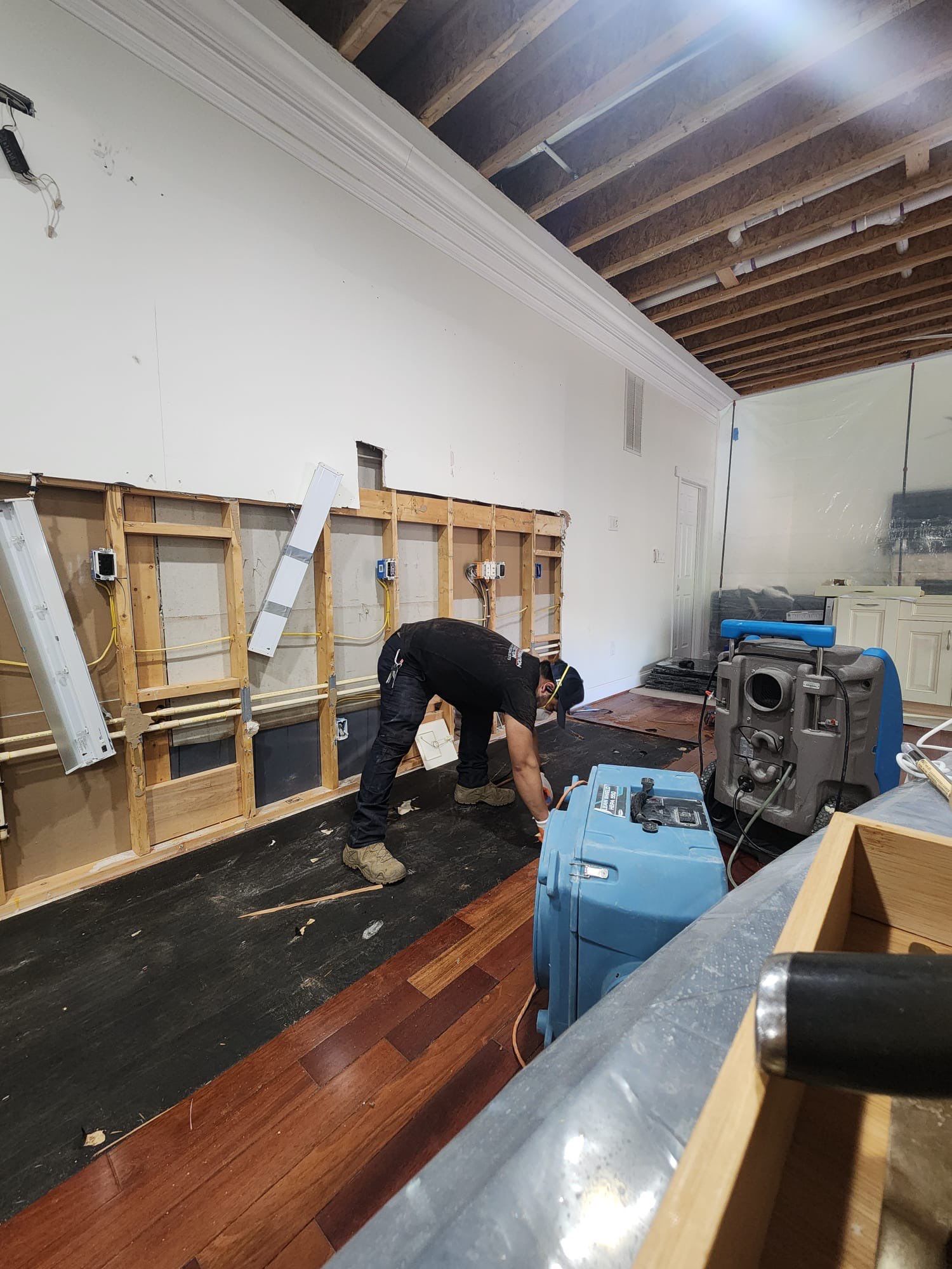 Standing water extraction underway during mold remediation in Marlboro, structural drying equipment deployed.