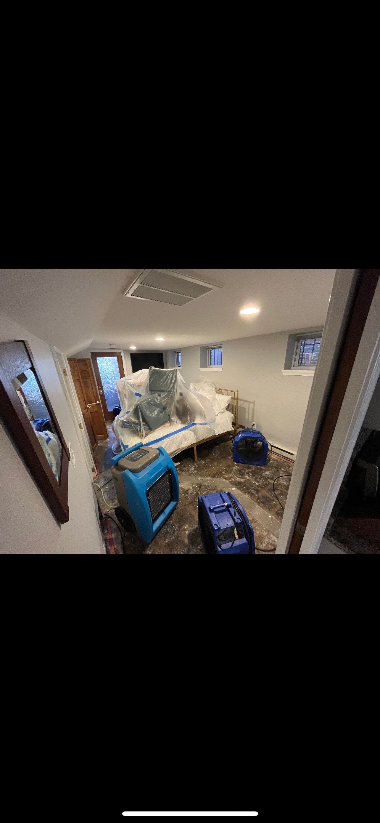 Standing water being extracted from flooded interior during Washington water damage restoration.