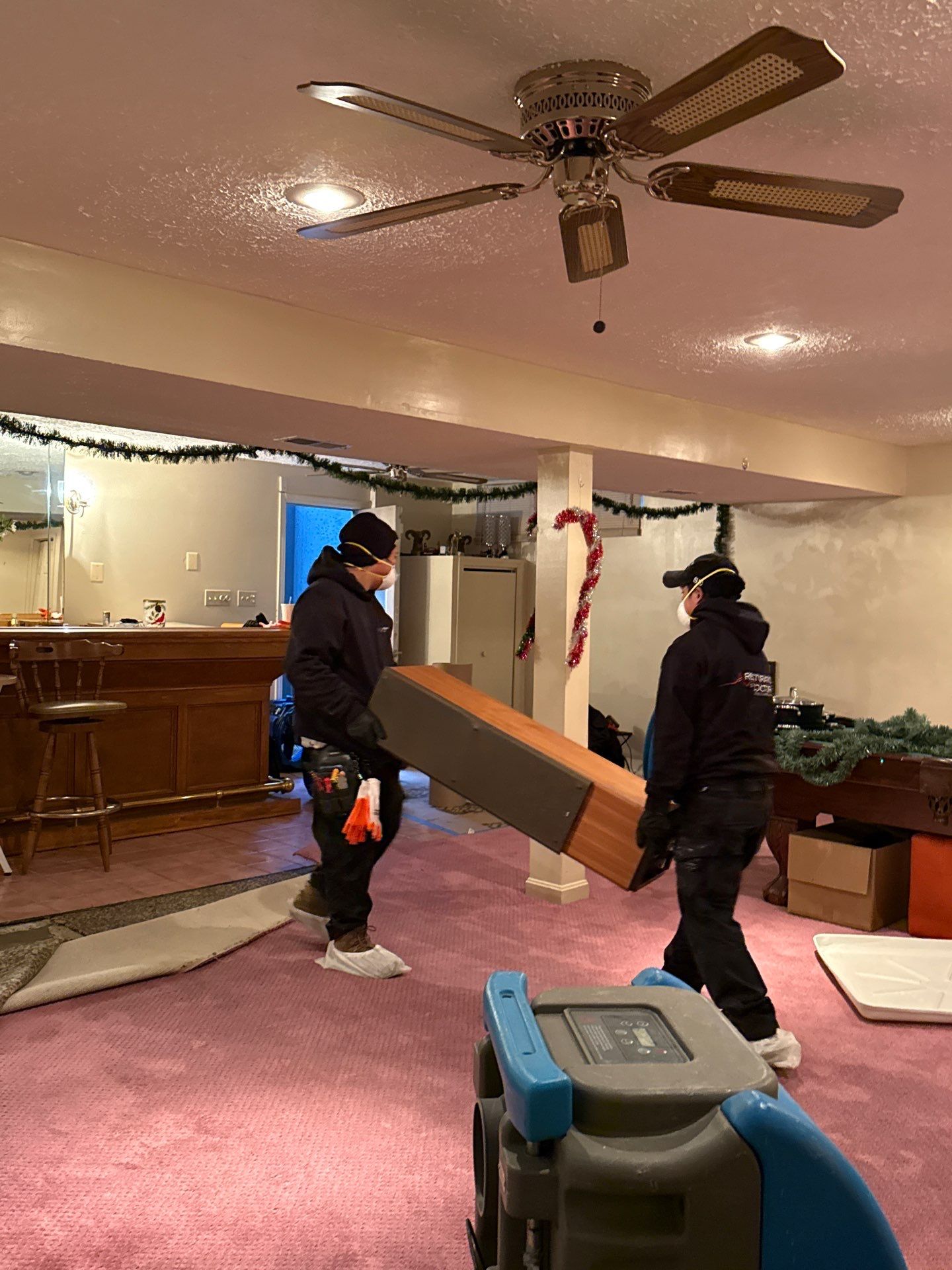 Dehumidifiers and air movers positioned for structural drying phase of water restoration.