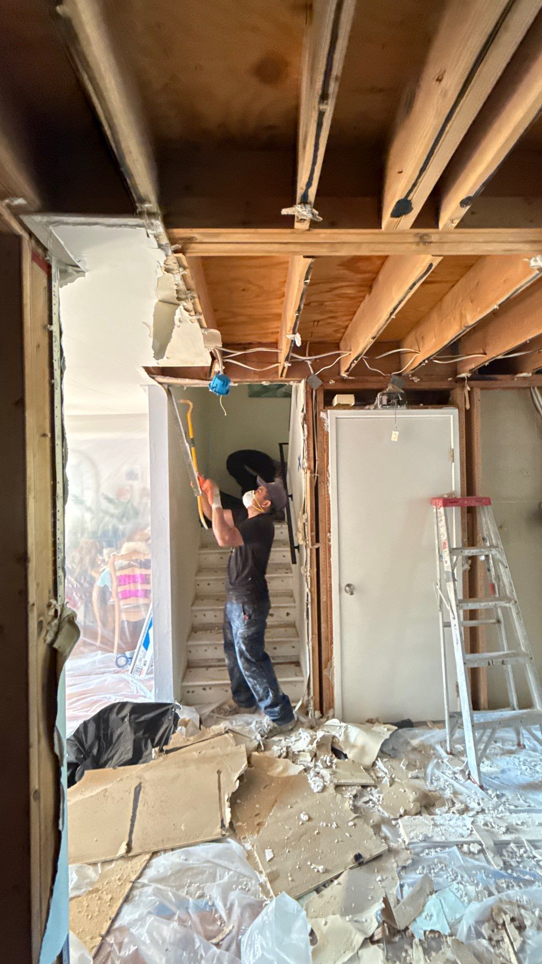 Mold remediation in Gaithersburg: affected ceiling cavity exposed, structural framing visible, drying equipment positioned.