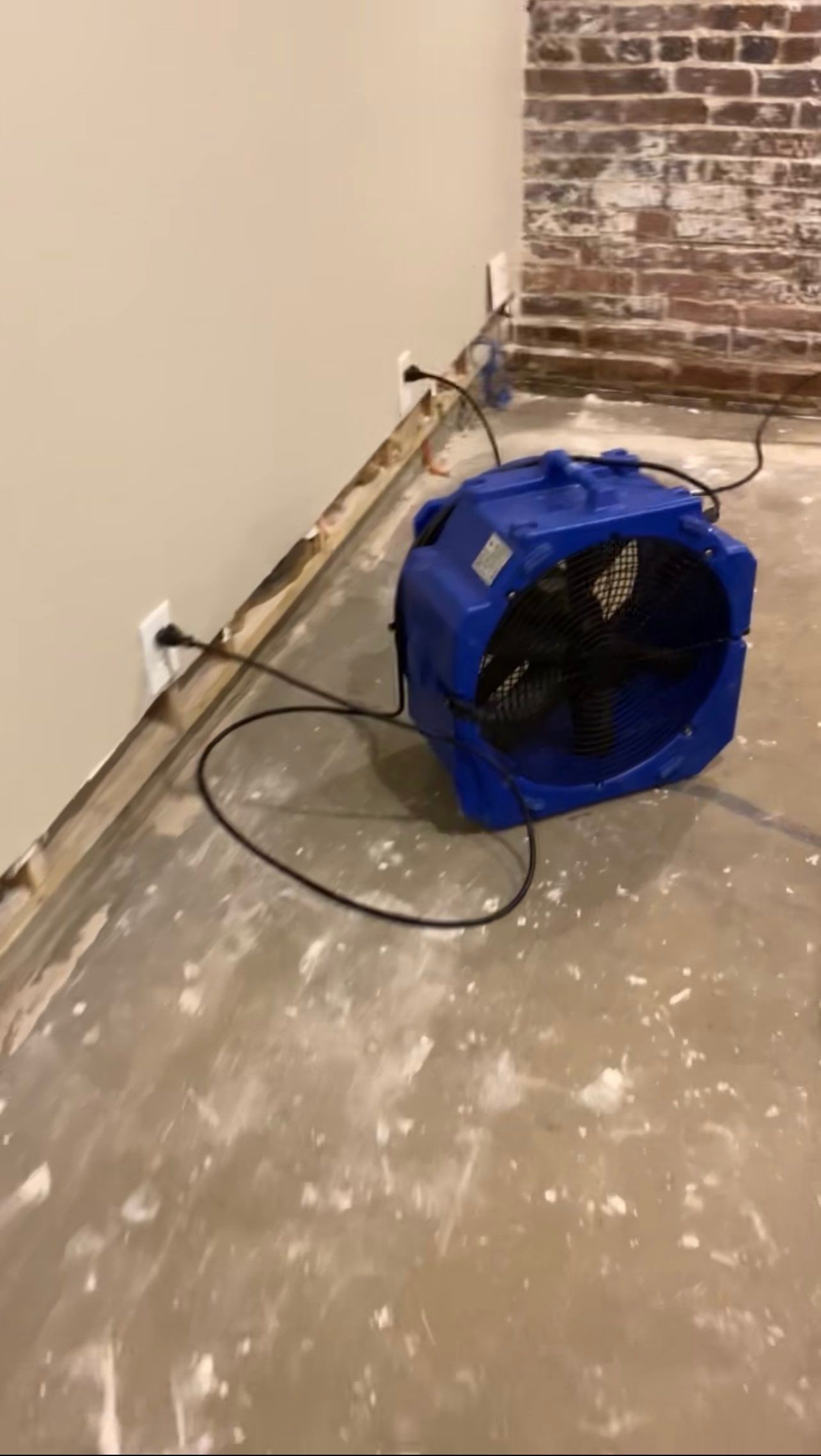 Dehumidifiers and air movers operating in water damage restoration process.