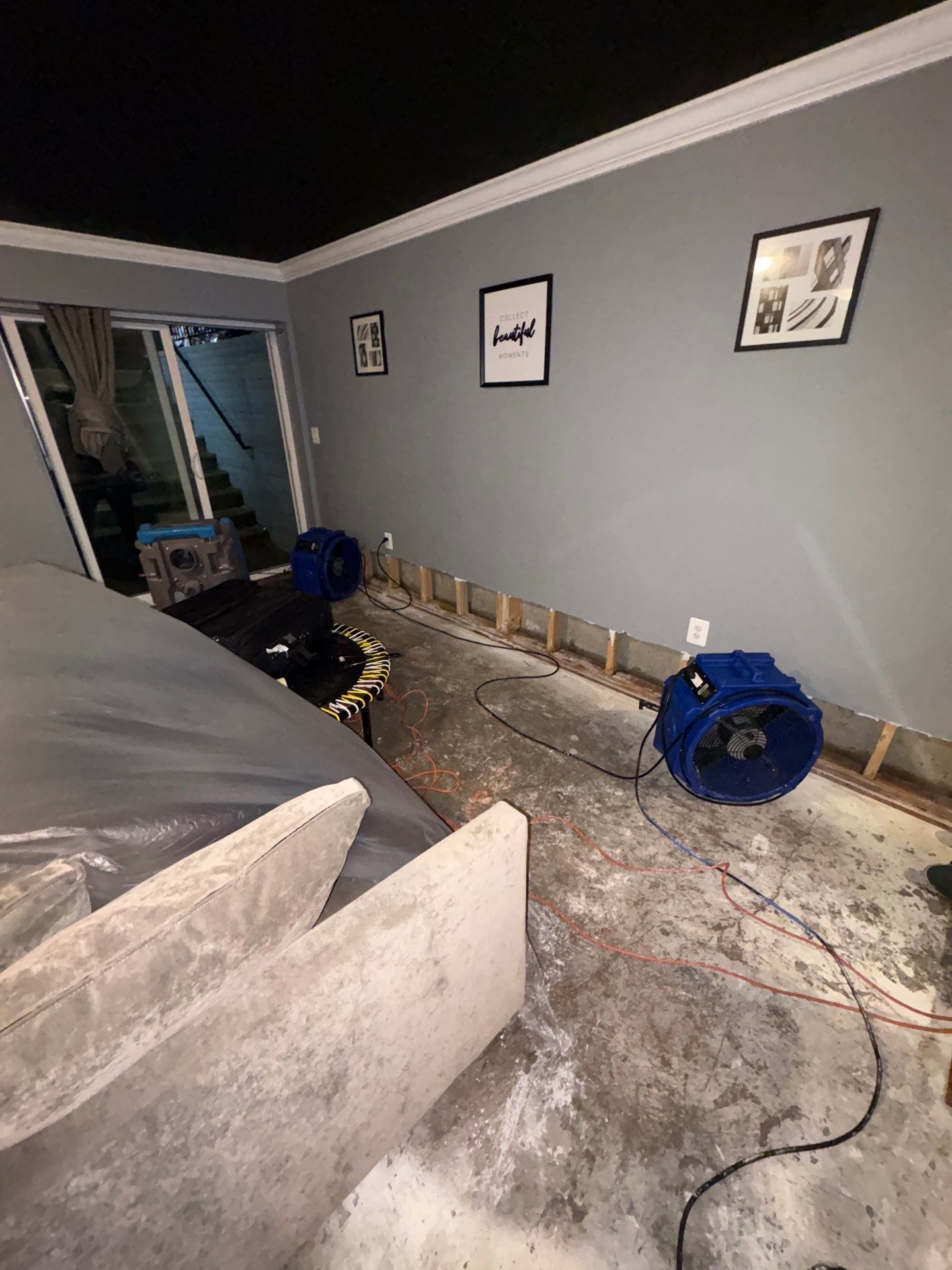 Continued drying phase with dehumidifiers and air movers operating in remediation space.