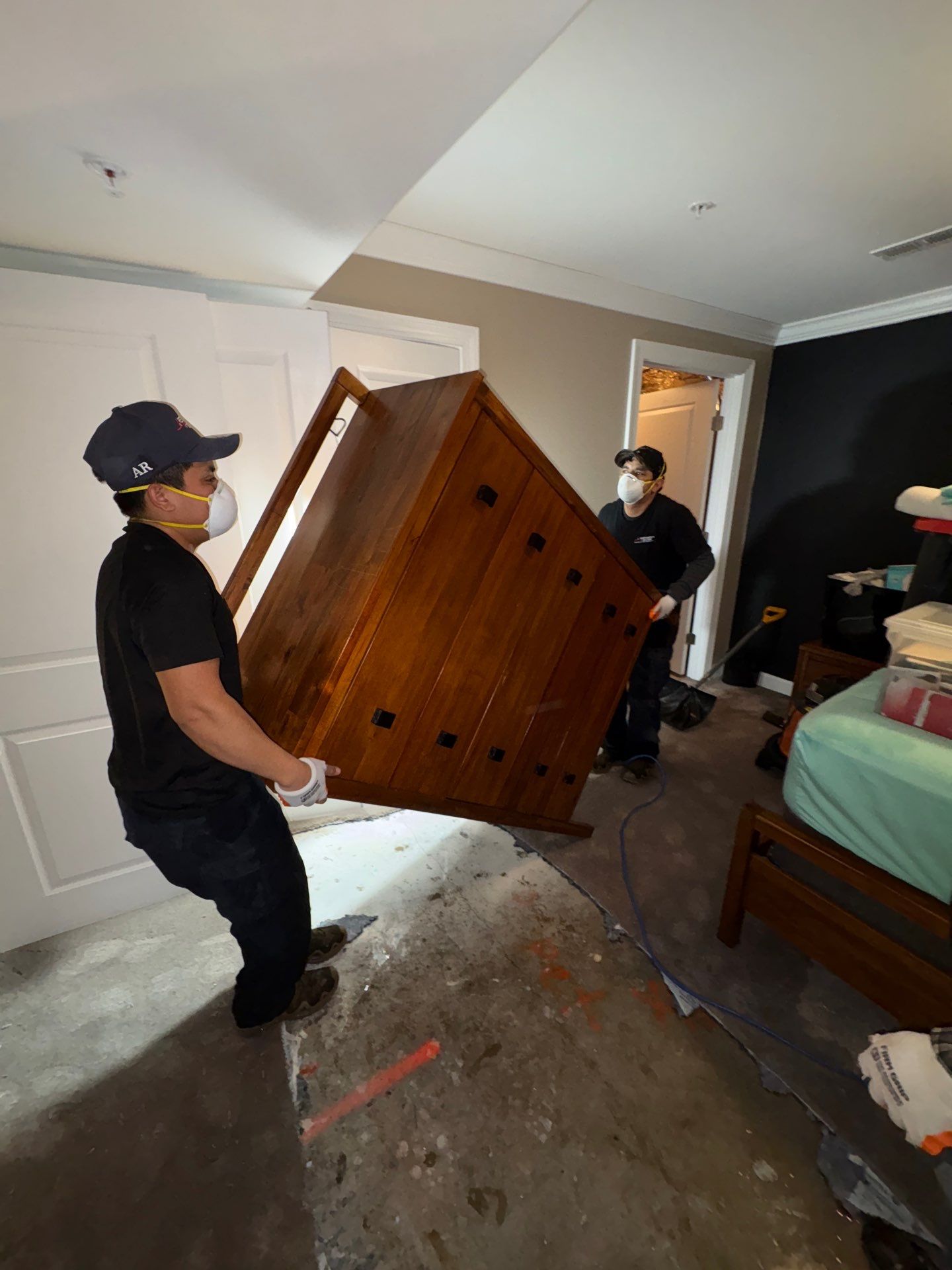 Baseboard removal exposing wall cavities for thorough drying and inspection.