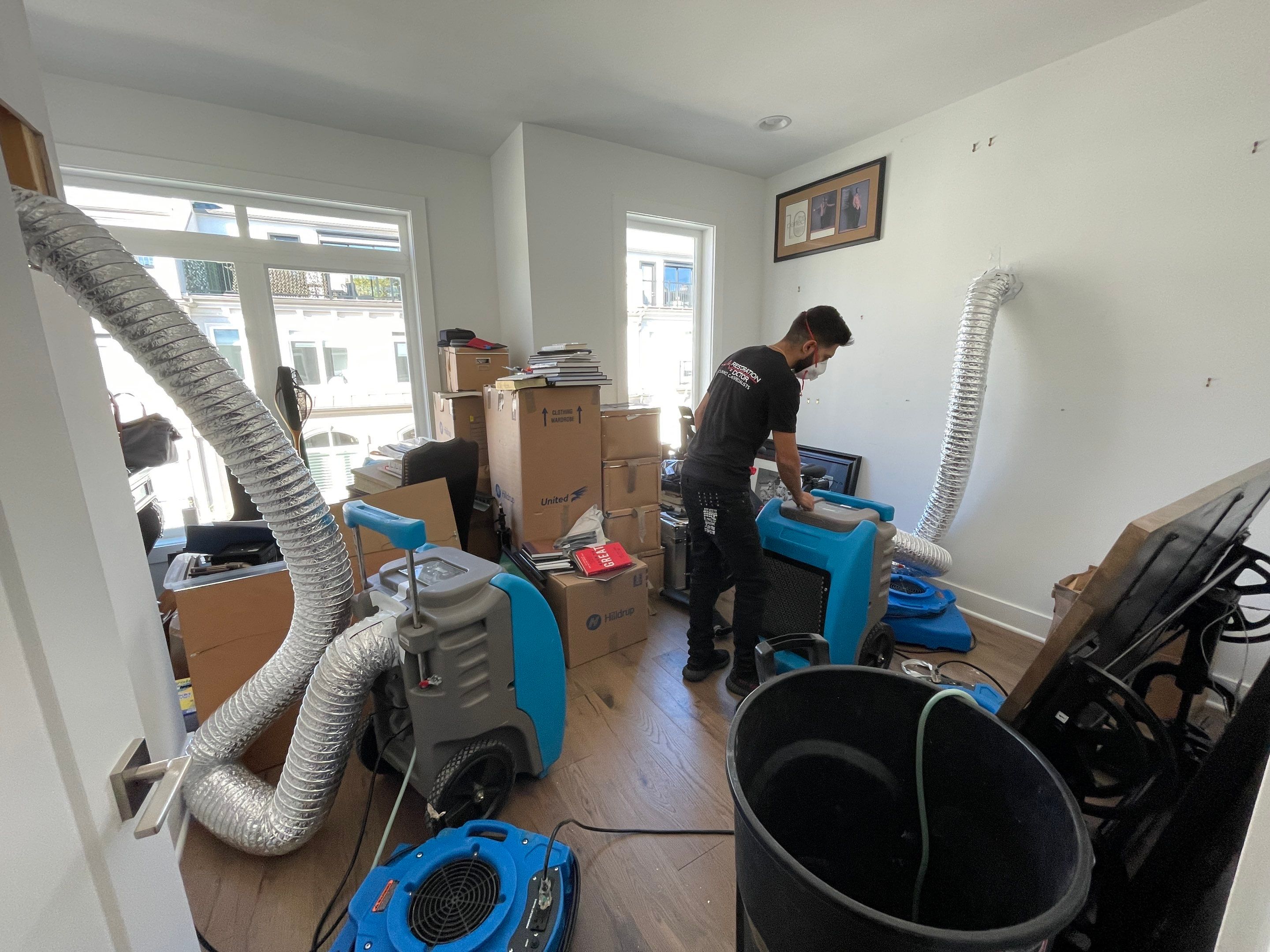Moisture monitoring and continued drying operations, equipment positioned to address remaining dampness in materials.