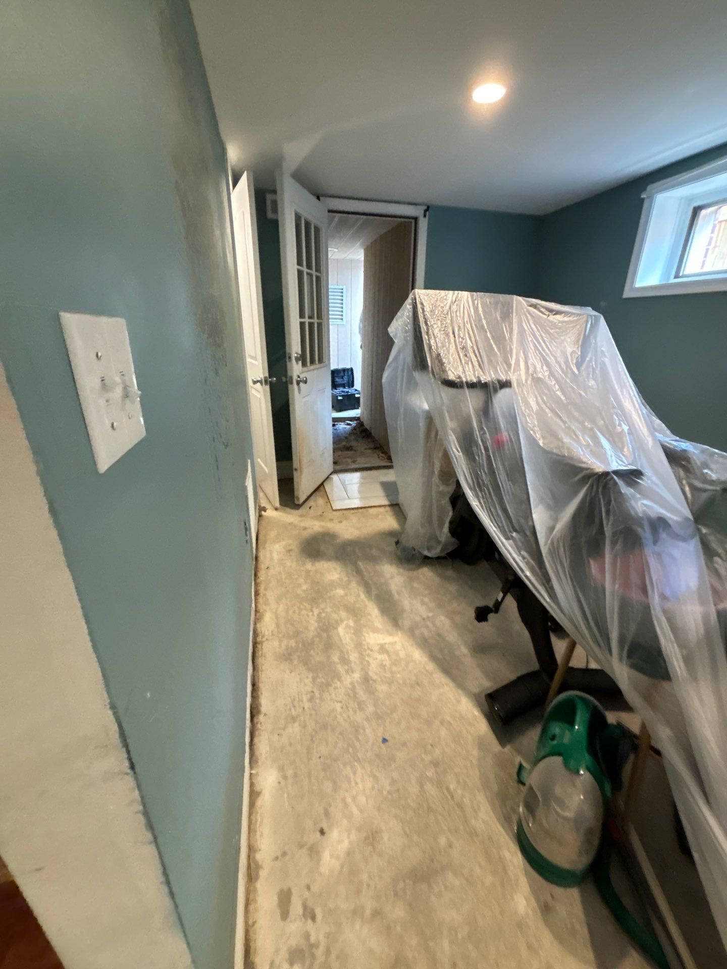 Structural drying in progress with dehumidifiers and air movers on affected ceiling area.
