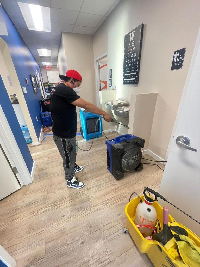 Standing water extraction underway in Bethesda water damage restoration, removing pooled water from affected interior space.