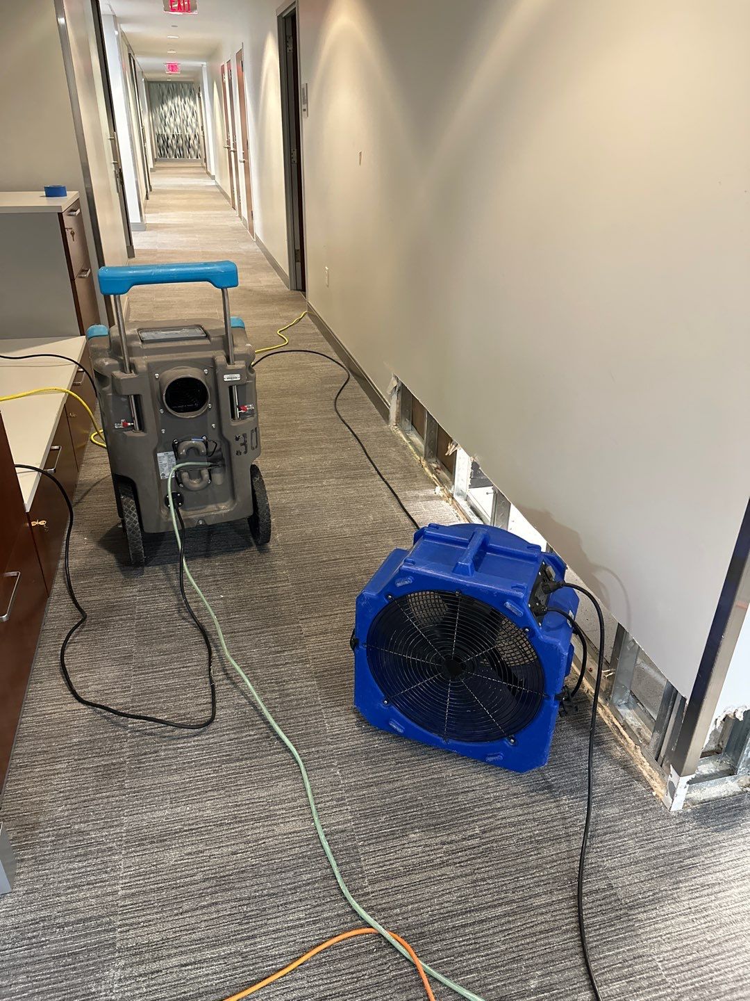 Dehumidification equipment positioned to manage moisture levels during the drying phase of water damage restoration.