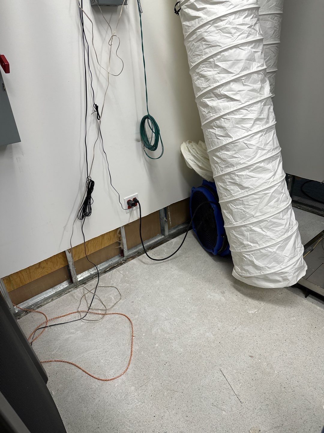 Structural drying in progress with air movers and dehumidifiers working to remove residual moisture from building materials.