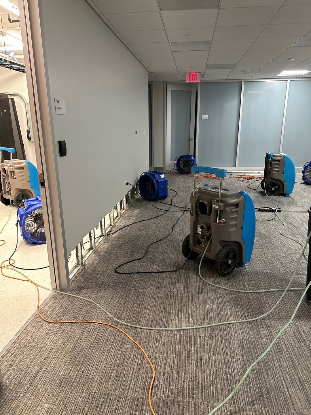Standing water extraction underway during water damage restoration in Washington, removing pooled water from affected interior space.