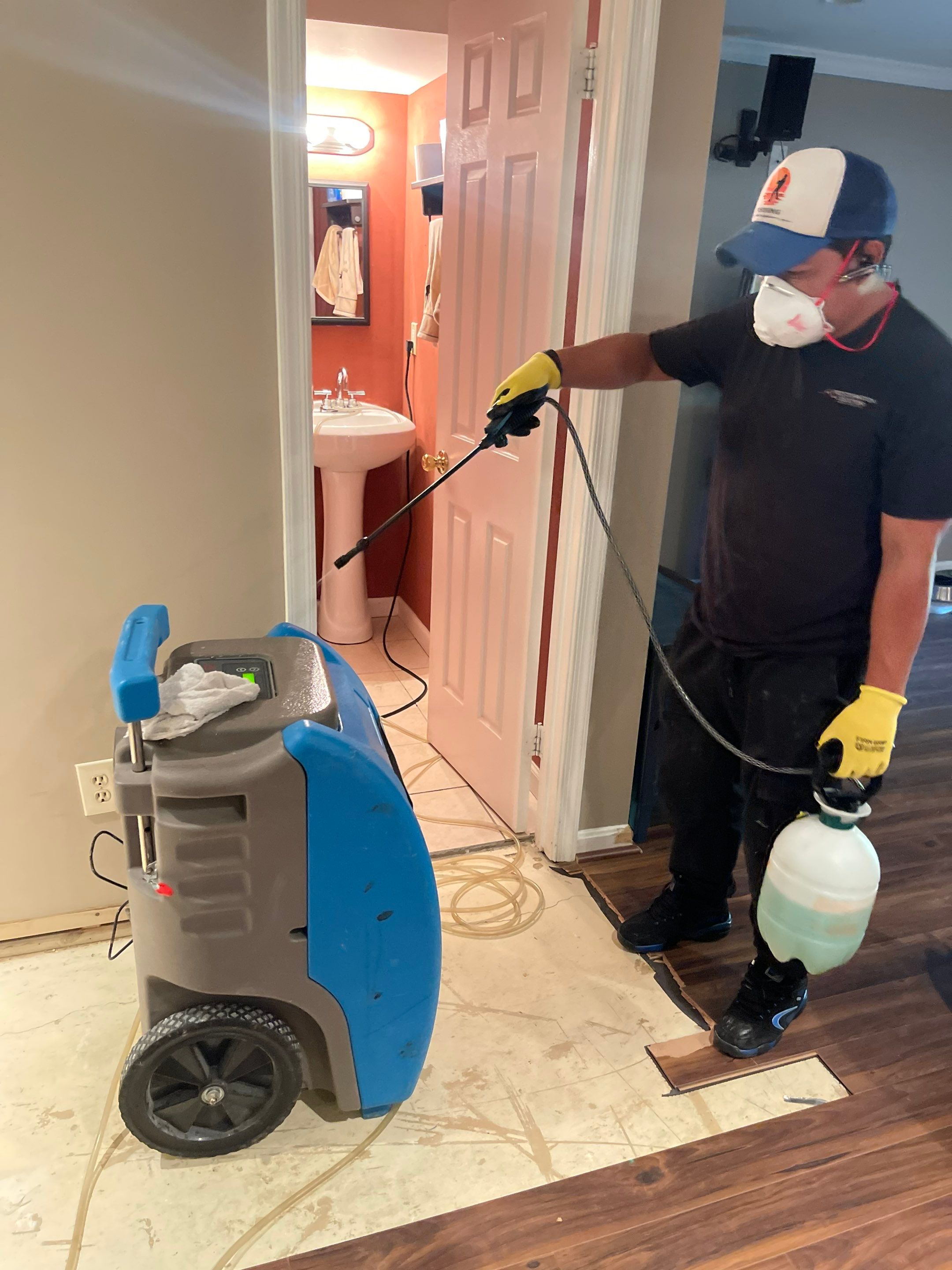 Structural drying equipment positioned throughout affected room during water restoration process.