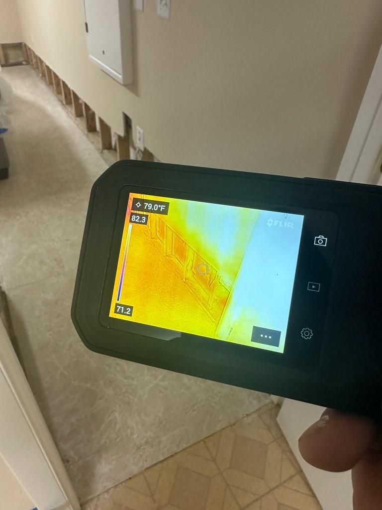 Structural drying in progress with air movers and dehumidifiers working to extract residual moisture from building materials.
