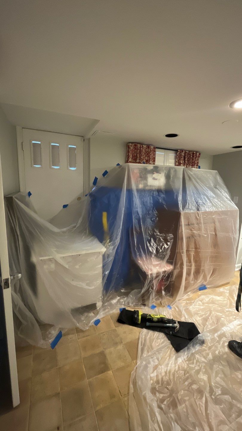 Drying equipment monitoring and sanitizing application in progress on water-damaged surfaces.