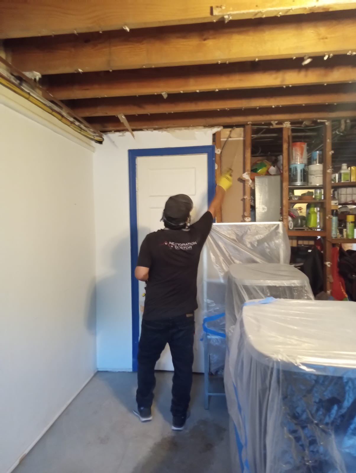 Structural drying in progress with dehumidifiers and air movers during mold remediation.