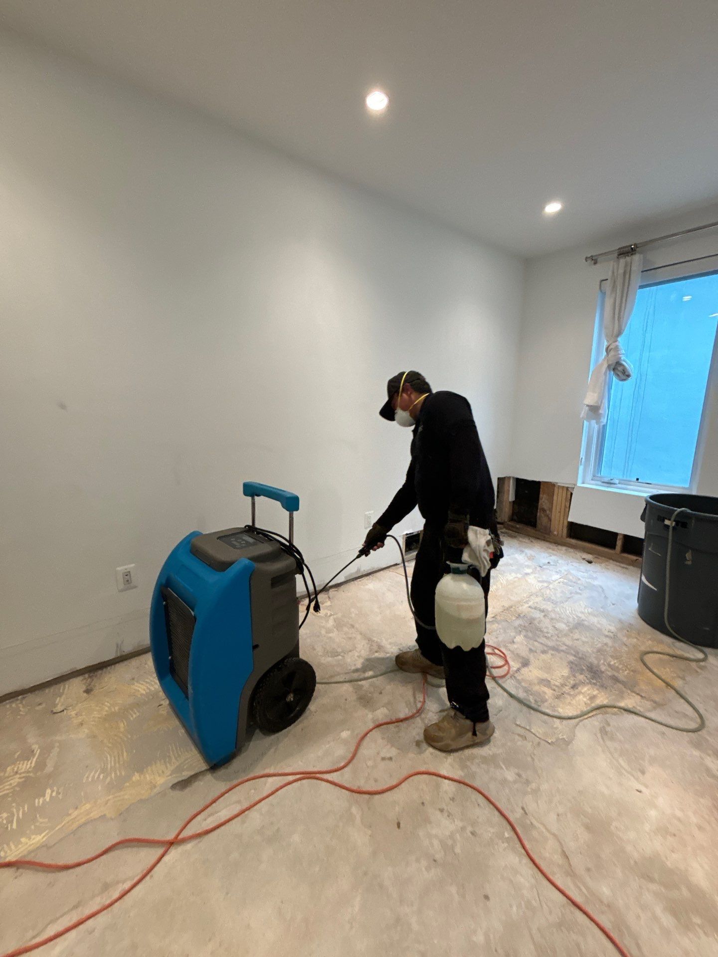 Dehumidifiers and air movers positioned throughout affected areas during active drying phase.