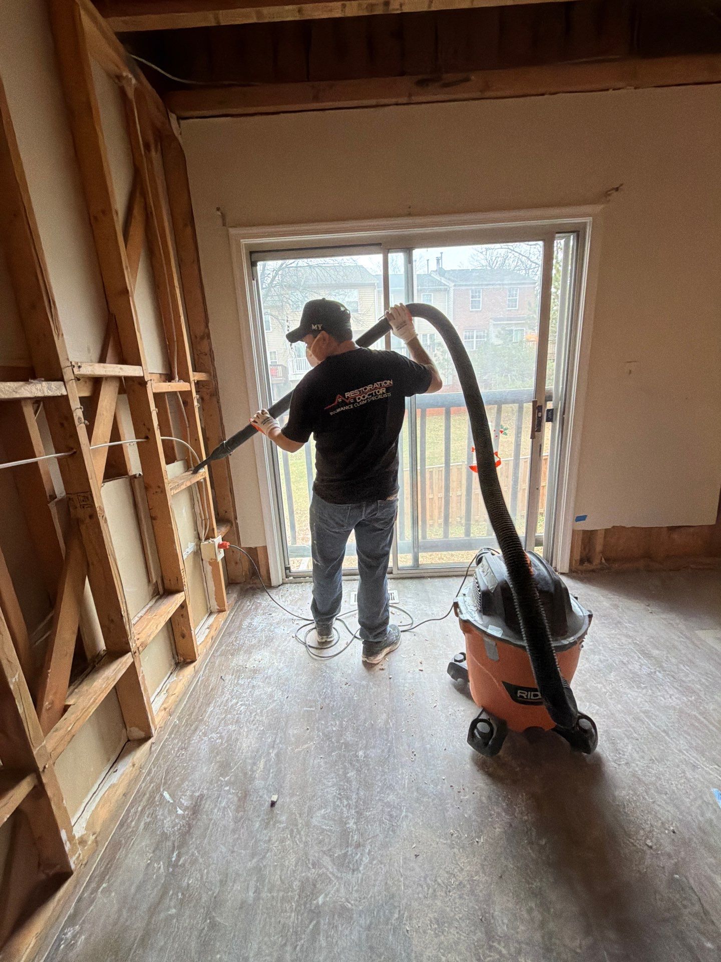 Dehumidifiers and air movers working to dry building materials following water removal.