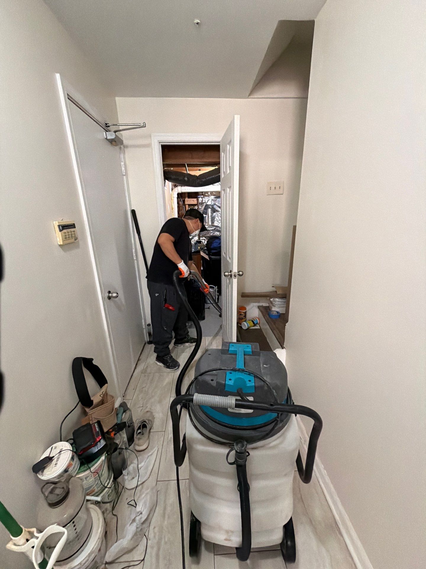 Standing water removal begins in Hillcrest Heights mold remediation, extractors deployed across affected floor.