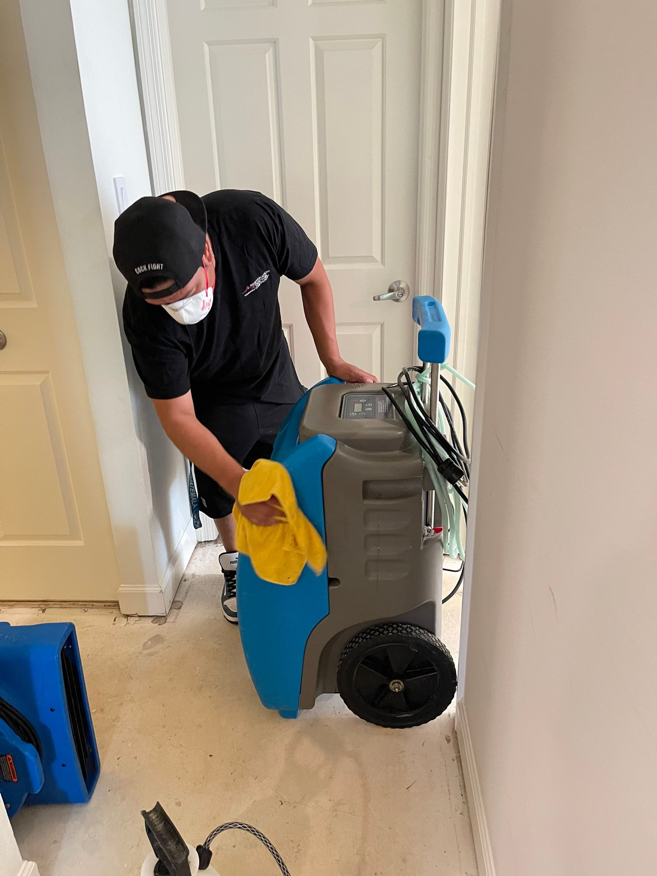 Dehumidifiers and air movers running to dry structural materials after water extraction in Gaithersburg.