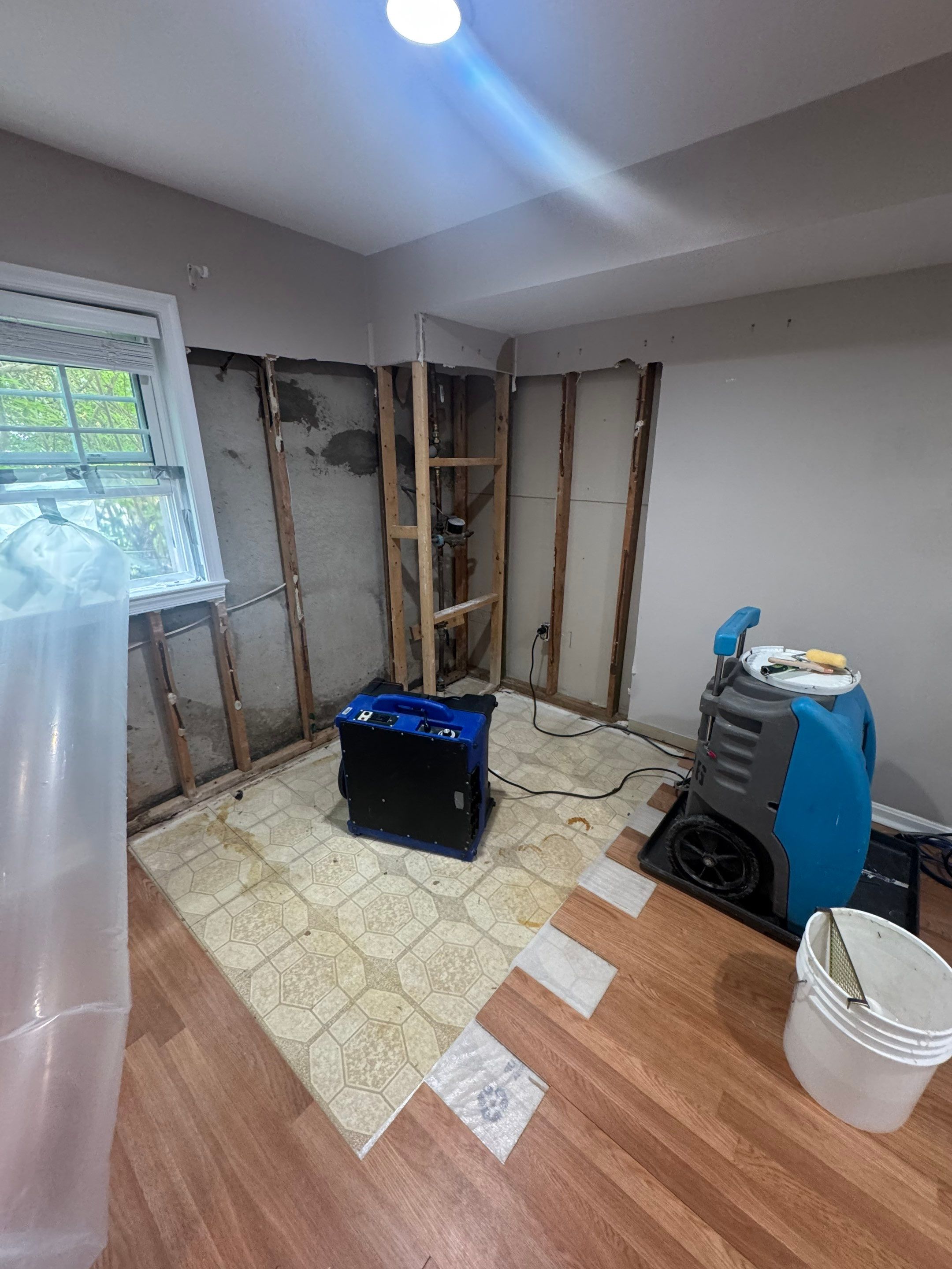 Structural drying equipment positioned to extract residual moisture from affected areas.