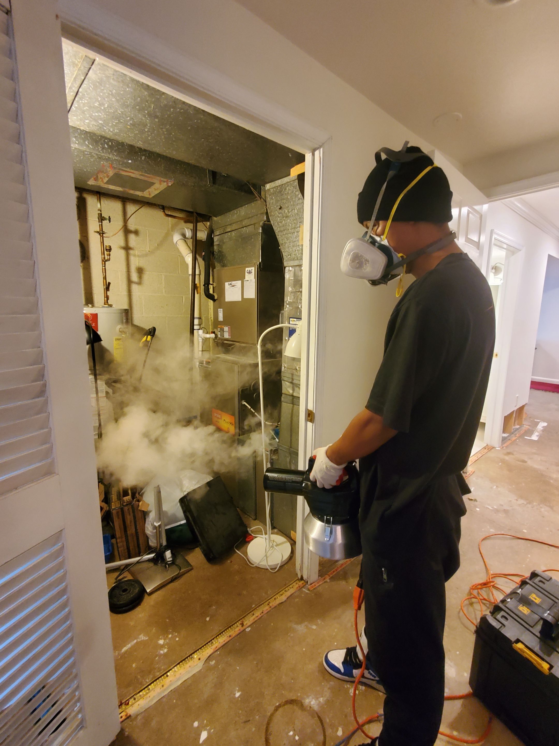 Standing water extraction underway in College Park water damage restoration, wet flooring visible.