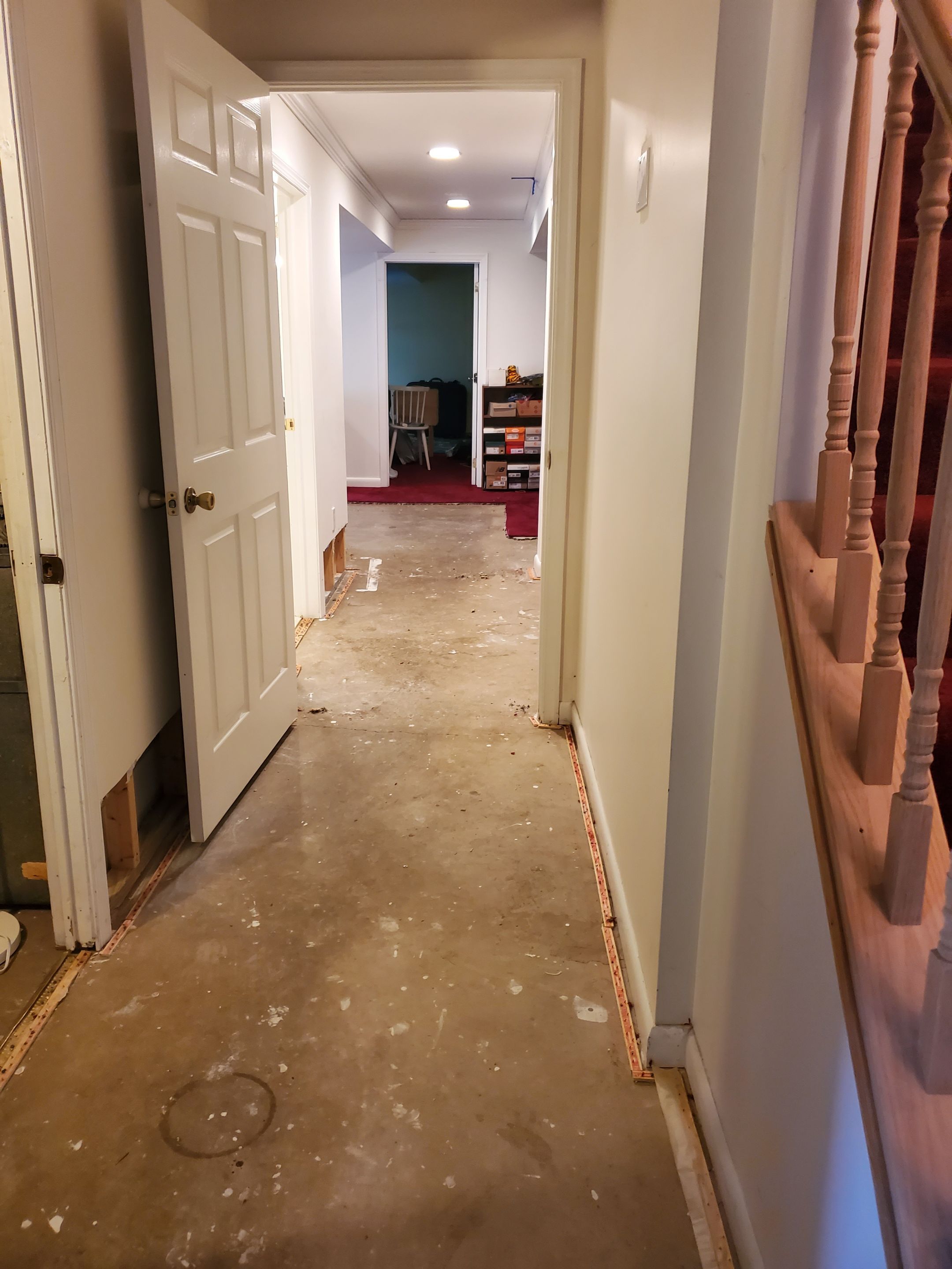 Dehumidifiers and air movers operating in water-damaged space for continued moisture removal.