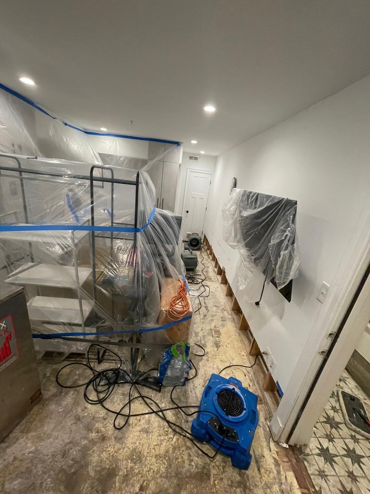 Standing water removal in progress during Washington water damage restoration.